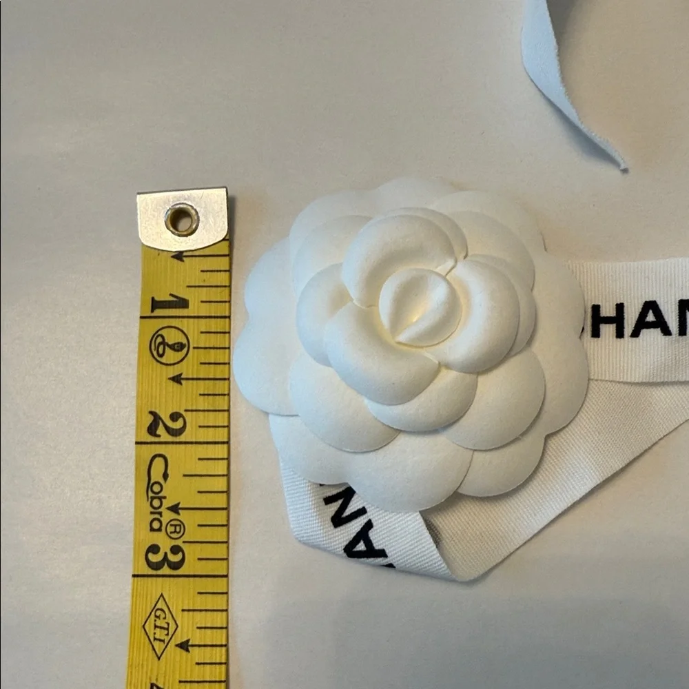CHANEL 1 CAMELIA FLOWER AND Silver Chanel printed RIBBON,  plus Chanel card.